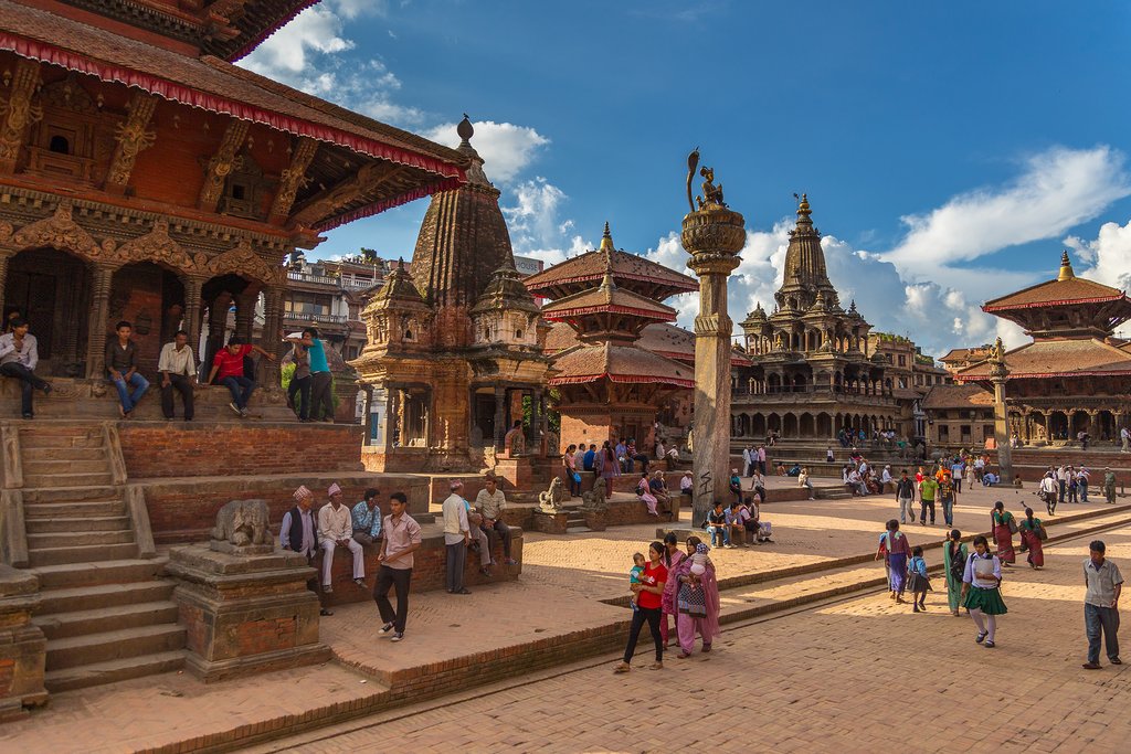 locals and tourists walking on the courtyards of Patan Durbar Square